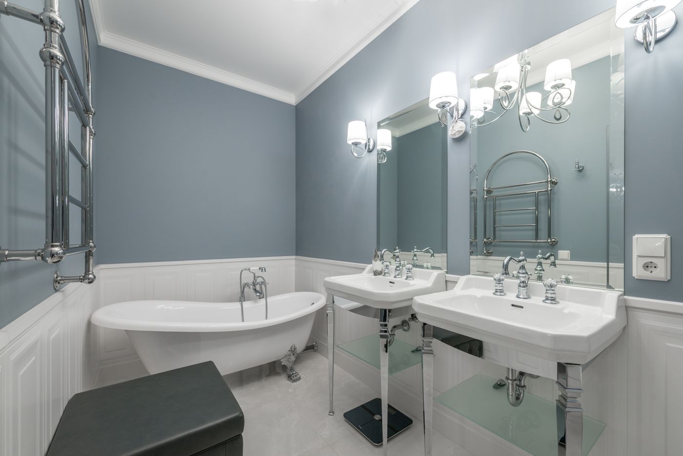 Classic bathroom with a freestanding bathtub, two sinks and soft blue walls